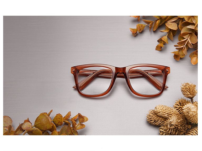 Value-priced square glasses #125215 in translucent brown surrounded by fall foliage on a tabletop.