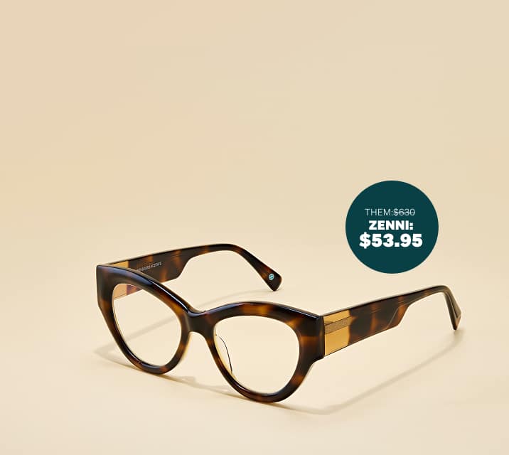 Tortoiseshell cat-eye sunglasses with thick temple arms with gold detailing, on a beige background.