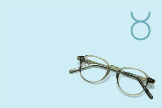 A pair of moss green glasses on a light blue background.