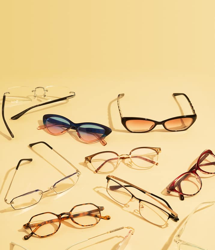 Assortment of fashion-forward Zenni frames arranged on a warm golden surface.
