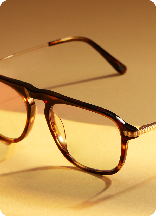 Tortoiseshell Stargazer Zenni frames with a retro-inspired design, photographed on a light golden surface.