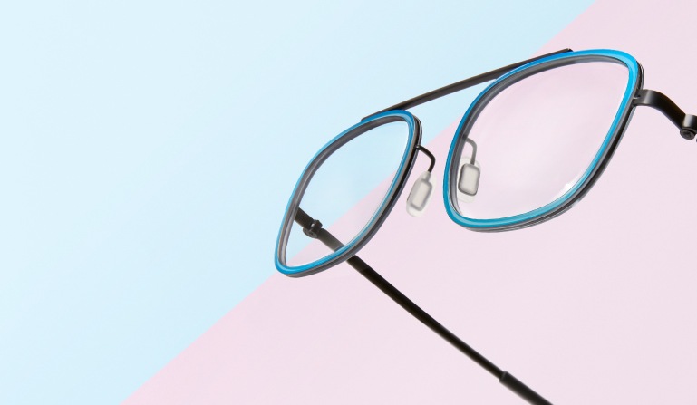 Floating pair of bridgeless rectangle glasses #7818116 with teal metallic rims.