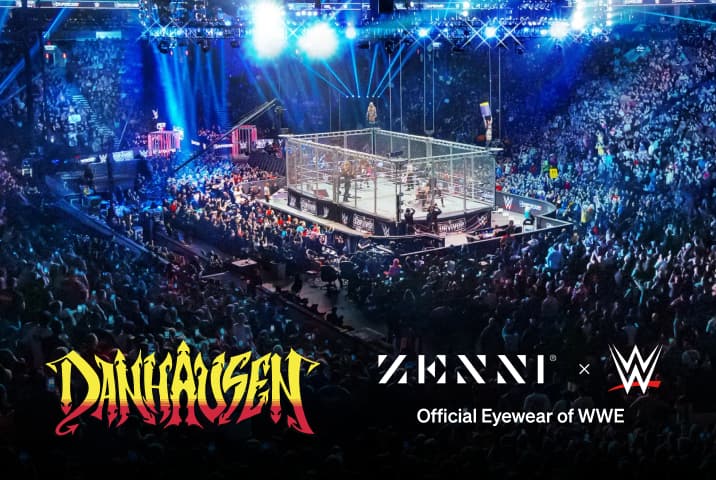 The Danhausen logo (yellow and orange graffiti style letters), over a background image of a large crowd watching a live wrestling match held on a stage within a large cage.