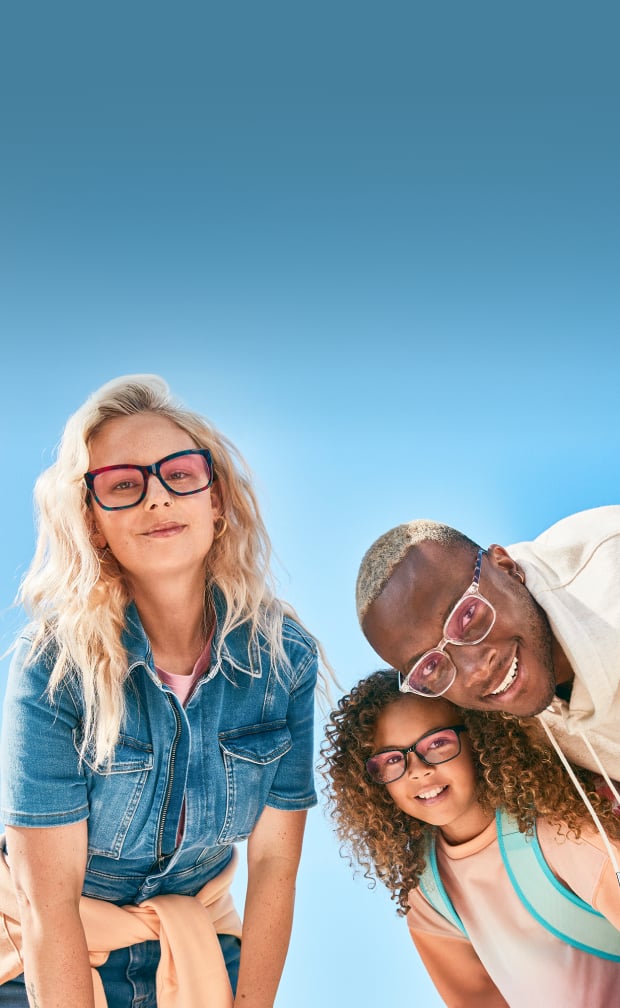 Group of three people—an adult woman, adult man, and child—all wearing glasses with Zenni ID Guard, smiling under bright daylight with a clear blue sky background.