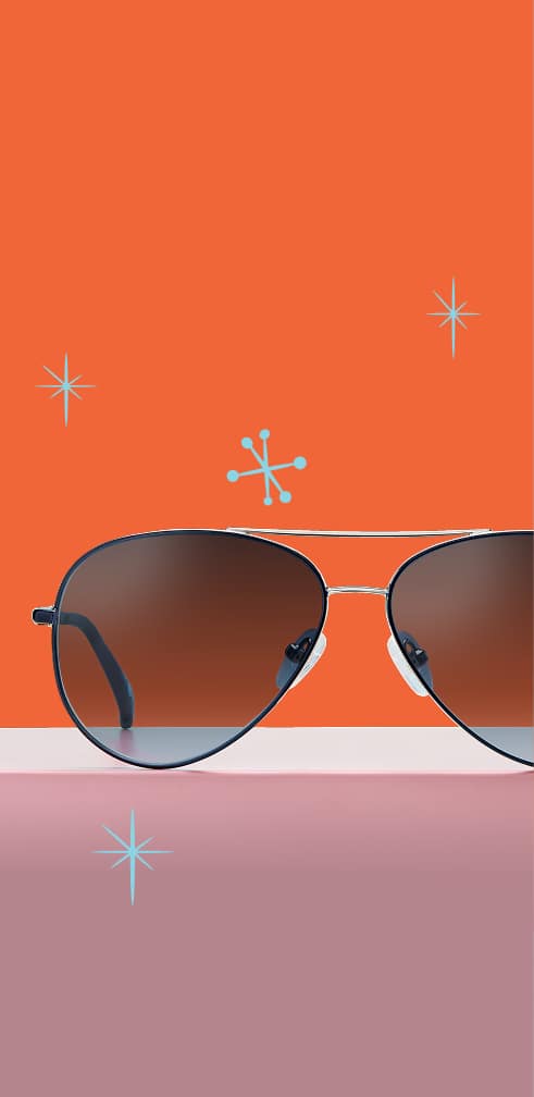 Lentes de Sol de aviador Zenni sobre un fondo naranja y rosa.