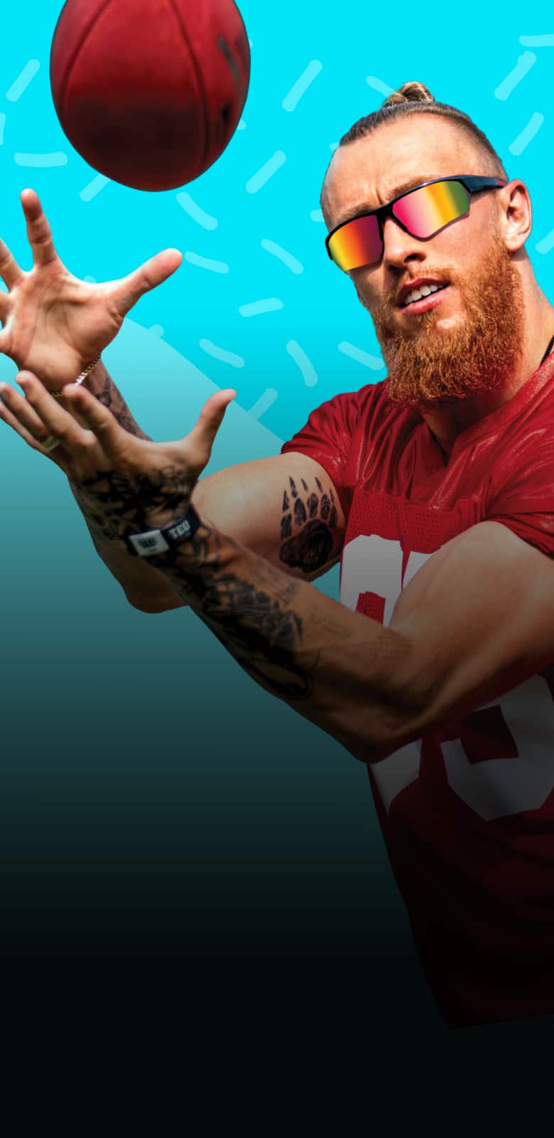 George Kittle wearing mirrored Zunnies sunglasses in action, reaching to catch a football against a bright blue background.
