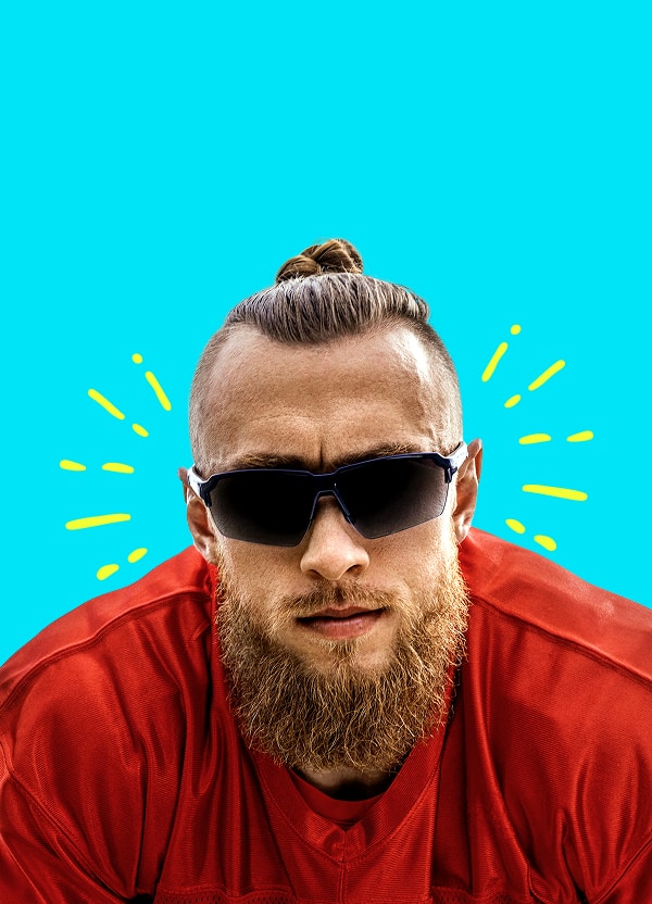 NFL player George Kittle wearing dark Zunnies sunglasses, facing forward in a red top with a determined expression.