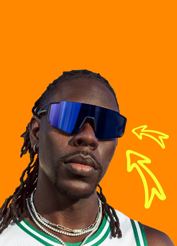 NBA player Jrue Holiday wearing blue mirrored Zunnies sunglasses with braids and a white jersey, set against an orange backdrop.