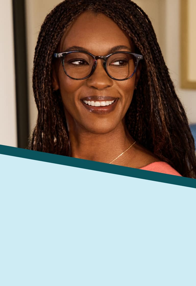 A woman with long brown and black braids wearing Zenni round tortoiseshell glasses. Background is a well-lit kitchen overlaid with a pale blue and teal pinwheel graphic.