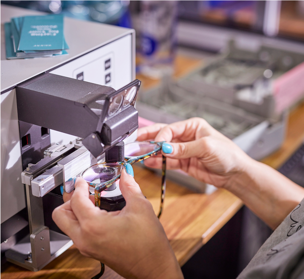 A Zenni employee is making a pair of glasses.