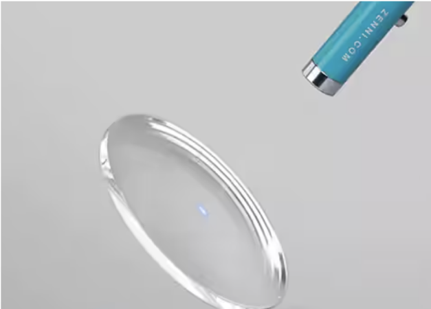Clear lens filtering a ray of blue light.