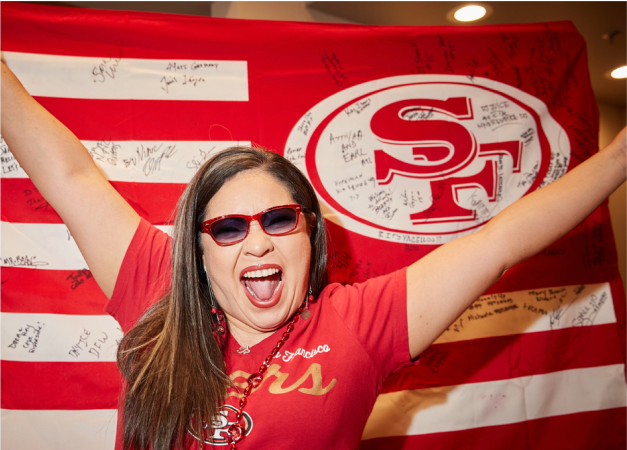 49er fan wearing red rectangle sunglasses.