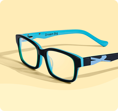 Black rectangular eyeglasses with a vibrant light blue inner lining and the inscription Dream Big on the inside of the temple arm, resting on a soft yellow background.