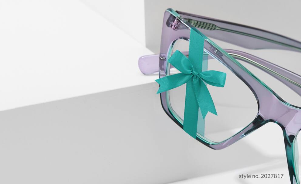 Zenni cat-eye glasses #2027817 in lavender with a teal bow tied on it.