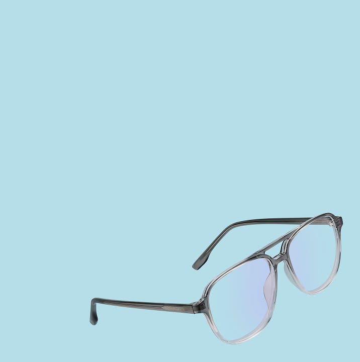 A pair of translucent grey aviator-style eyeglasses with blue light-blocking lenses, shown from a side profile against a solid light blue background.