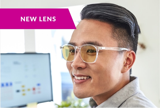 Image of a man wearing Zenni glasses with blokz anti-fatigue lenses in them, in an office setting with a note that says ‘new lens’.