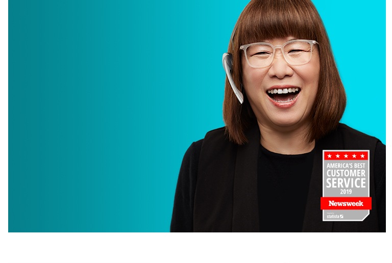 Happy Zenni customer service rep wears a headset and Zenni glasses.