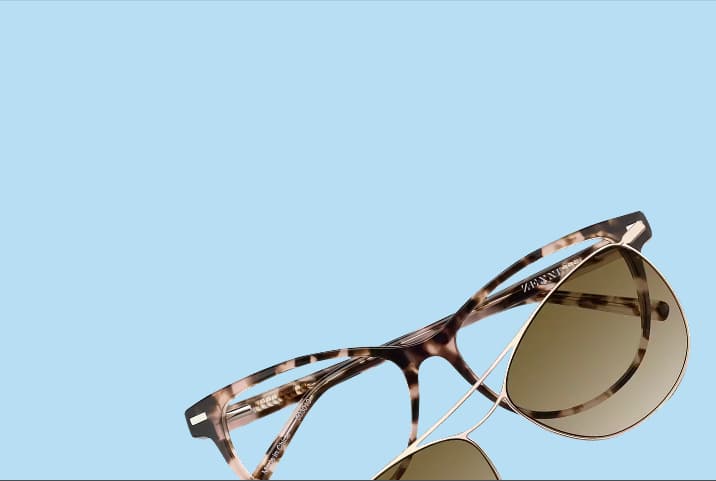 Zenni tortoiseshell eyeglasses with brown snap-on magnetic sun lenses against a light blue background.