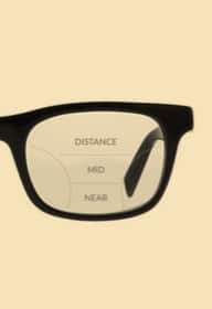 Progressive glasses starting at $35 (compare to $329). Zenni square glasses showing progressive lens strength distance on lens, on a cream color background.