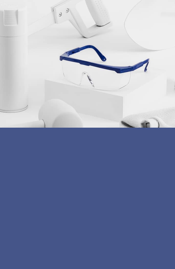Image of Zenni protective goggles #A70180316 on a white platform, surrounded by tools that are painted white.