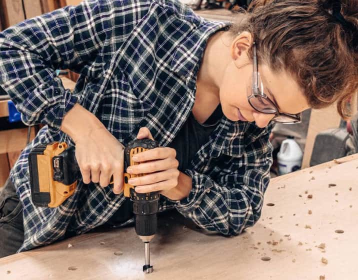 Image of a woman using a power drill, wearing Zenni Z87.1 safety glasses #749812.