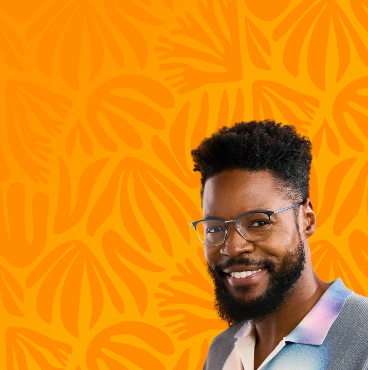 Smiling man wearing blue eyeglasses and a pastel ombré shirt, standing in front of a bold orange background with abstract hand shapes; style no. 1302016.