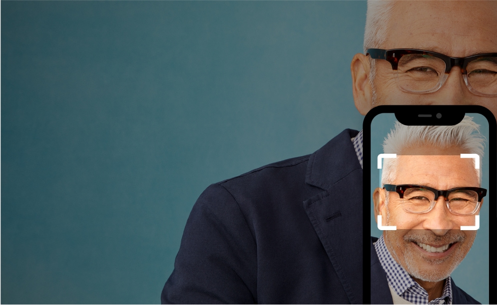 A man wearing browline glasses with an overlay of a phone taking a picture of the man and a rectangle focusing on the glasses.