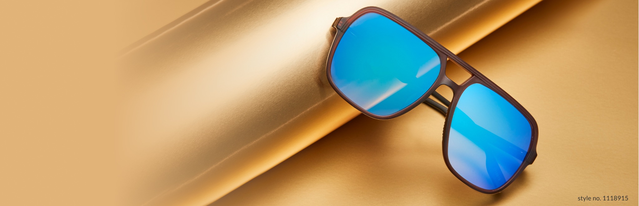 Image of Zenni premium aviator glasses #1118915, against a gold background with a roll of gold wrapping paper.