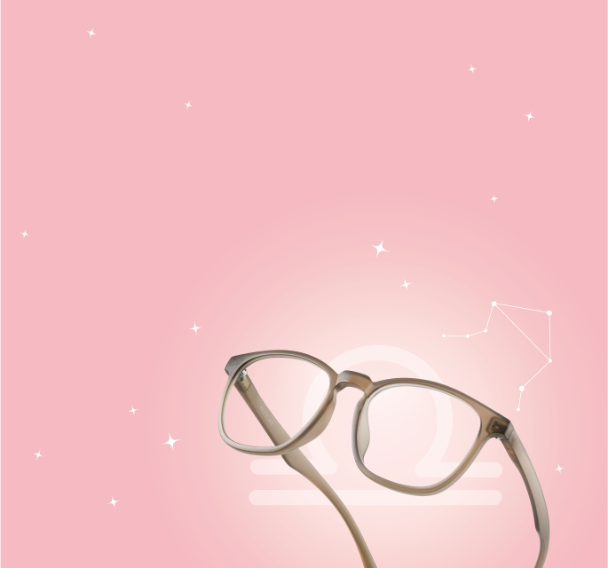 Soft blush-toned Zenni frames on a pink background with Libra symbol and constellation.