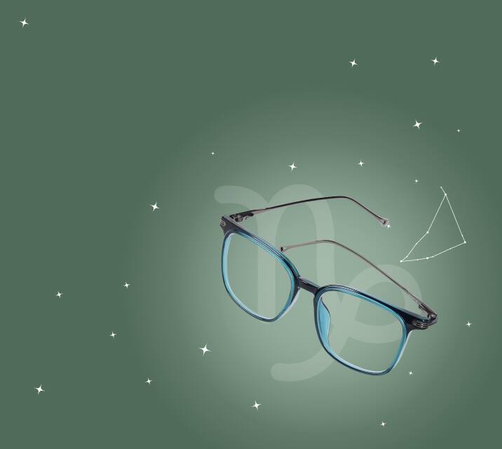 A pair of black and light blue rectangular glasses floating on a dark green background with white stars and the outlined constellation for Capricorn.