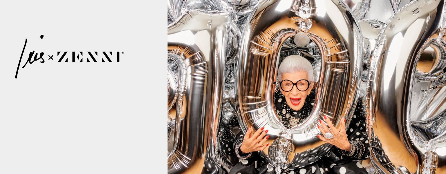 Iris and Zenni. Image of fashion icon Iris Apfel wearing zenni iris apfel round glasses #4452518. Iris is wearing red lipstick and nail polish, and holding silver mylar number balloons that spell 100.