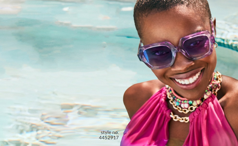 Image of a woman wearing Iris Apfel x Zenni good to be square glasses #4452917 on a beach.