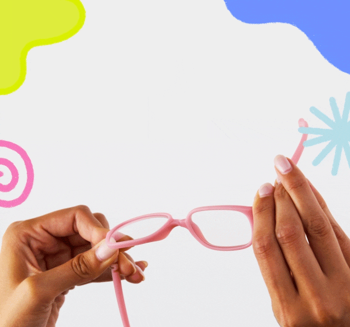 Hands twisting and bending pink flexible kids eyeglasses to highlight durability against a white background with playful doodles.