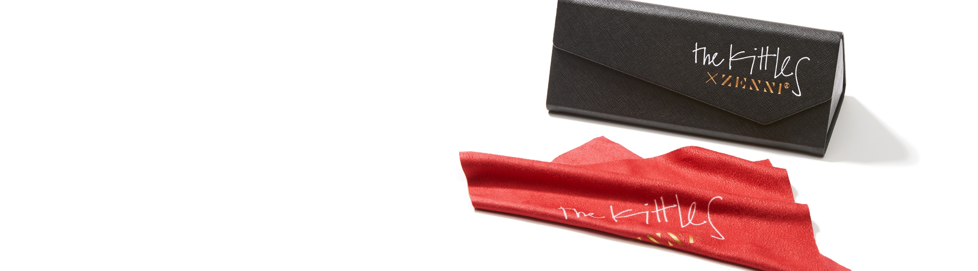 Special collection case and cloth included with all Kittles x Zenni eyewear. Image of a black trifold case and red cleaning cloth.