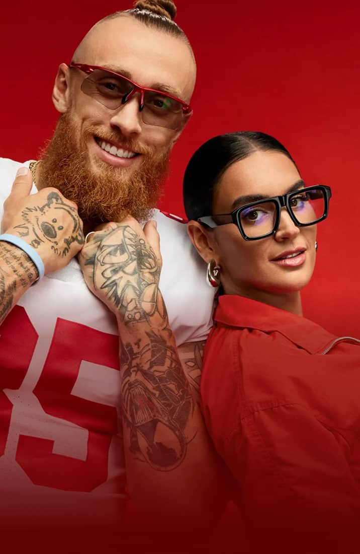 George Kittle in red framed Zenni sunglasses and Claire Kittle in black square Zenni glasses, on a red background.
