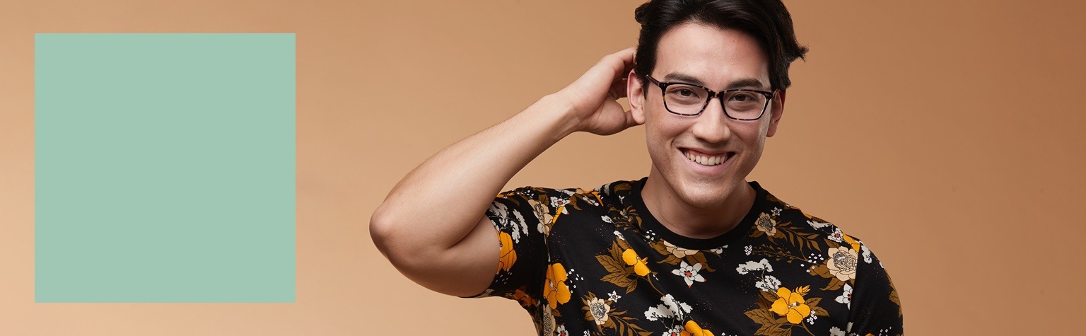 Man in a black floral t-shirt wearing tortoiseshell rectangle glasses #4439725.