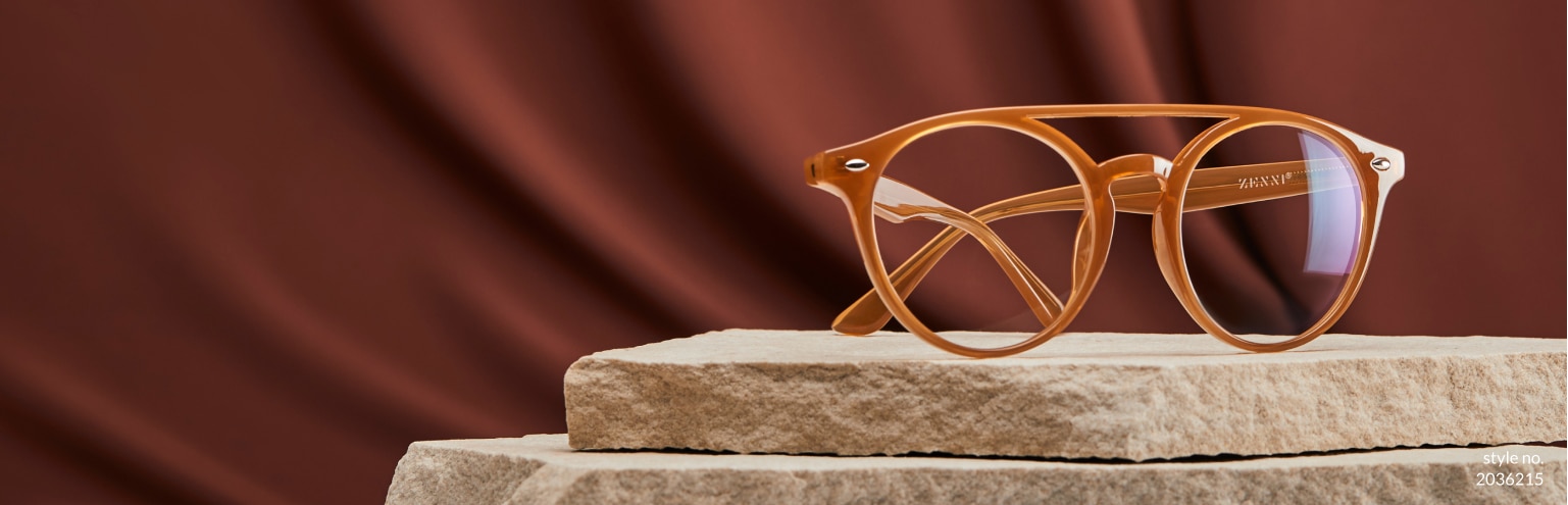 New and totally you. Set your sights on this season’s hottest new eyewear. Shop new arrivals. Image of Zenni aviator glasses #2036215, set atop a pile of sheet rock, in front of a warm brown background.