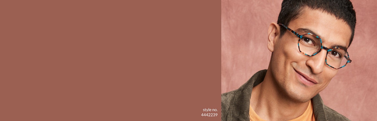 Men’s glasses. Set your sights on this season’s hottest new eyewear. Shop new arrivals. Image of a man wearing Zenni geometric glasses #4442239, wearing a corduroy jacket in front of a warm brown background.