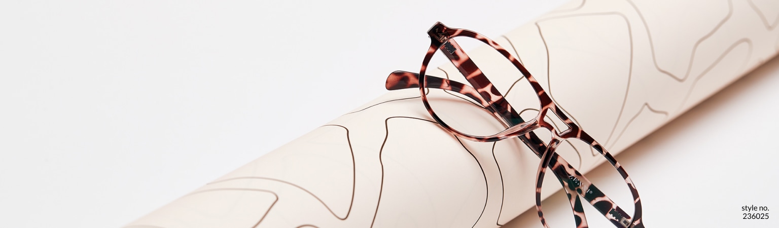 Image of a pair of Zenni aviator glasses #236025 against a roll of animal print wrapping paper.