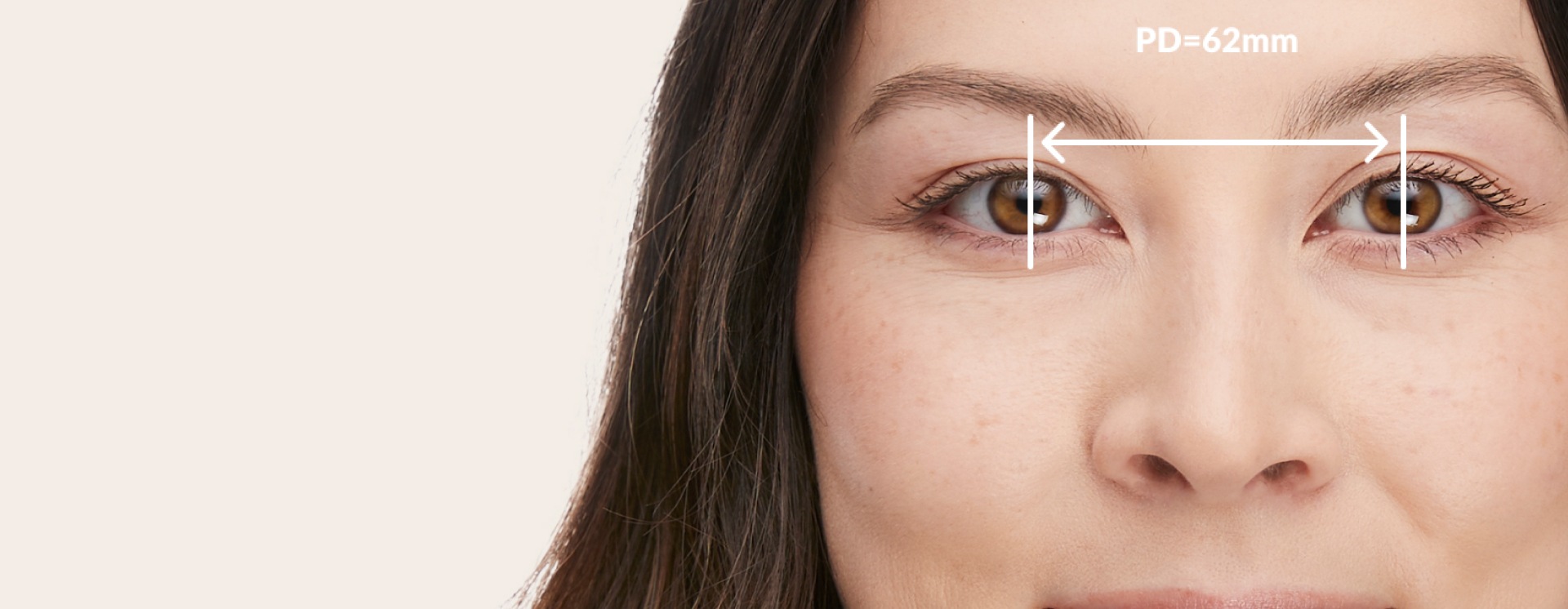 Image of a woman, with a measurement of her pupillary distance of 62mm.
