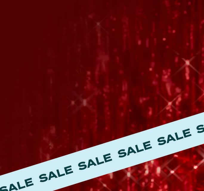 A shimmering red background with starburst highlights, and a light blue ribbon across with the word ‘sale’.
