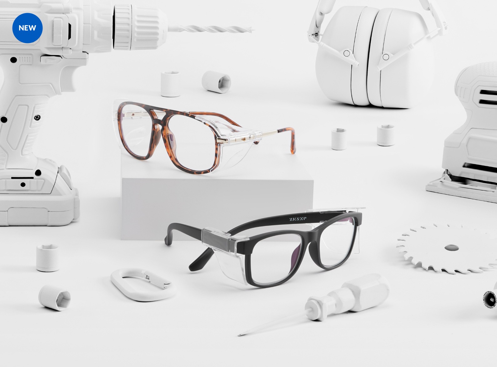Image of Zenni ANSI Z87.1 safety glasses #748425 and #748521, surrounded by a variety of white workshop tools.