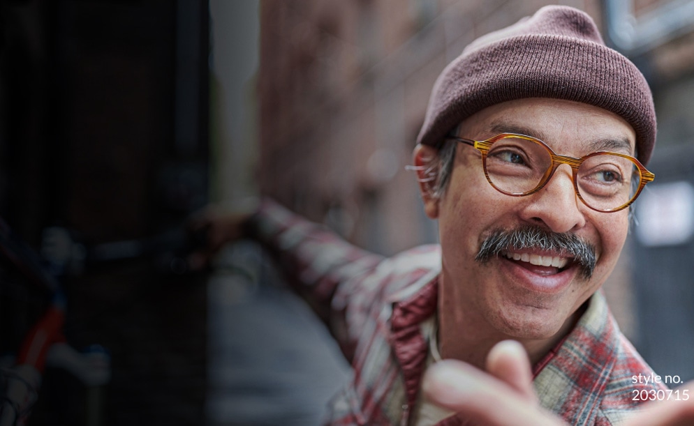 Image of a man wearing a beanie and Zenni glasses, with a big smile.