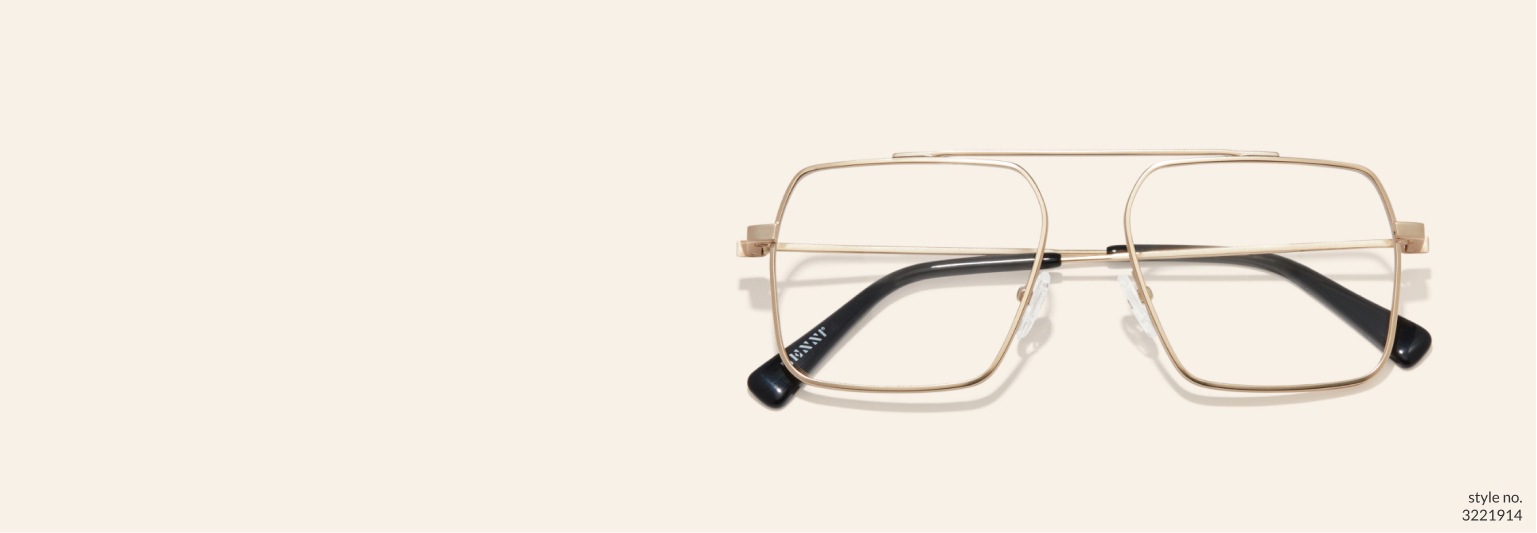 Image of Zenni gold aviator glasses #3221914 on a beige color background.