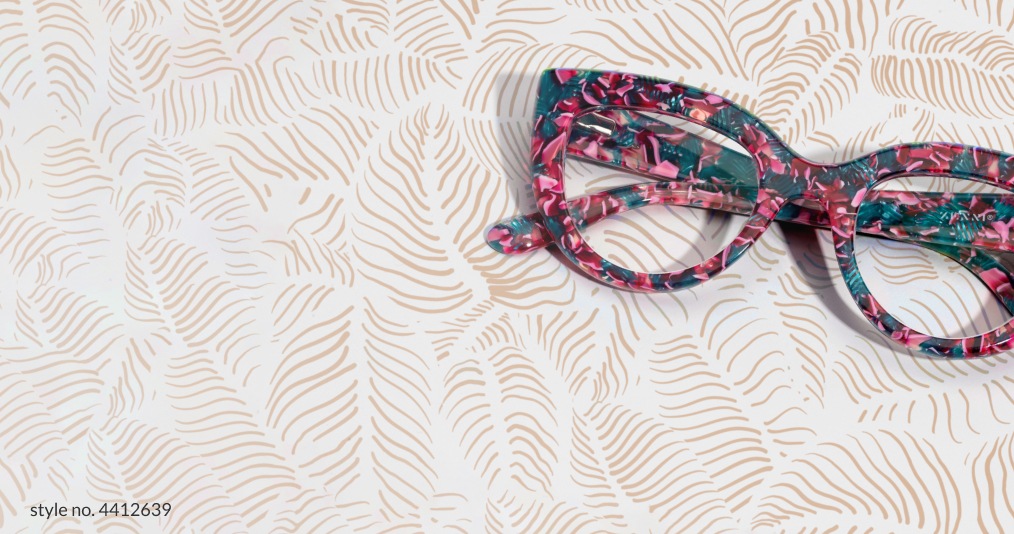 Image of Zenni green and purple floral cat-eye glasses on a brown leaf pattern background.