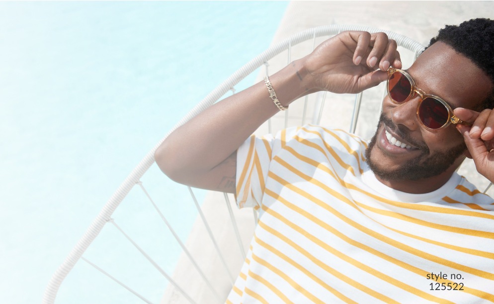 Image of a man wearing Zenni round sunglasses #125522 laying in a comfortable chair outside by the pool.