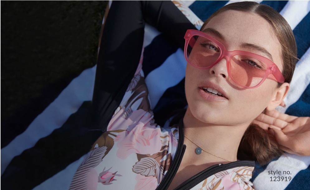 Image of a woman wearing Zenni square glasses #123919 laying on a striped towel.