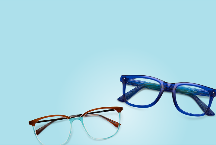 Two pairs of vibrant eyeglasses—one in translucent royal blue and the other with a brown-to-aqua gradient—placed on a bright light blue background.
