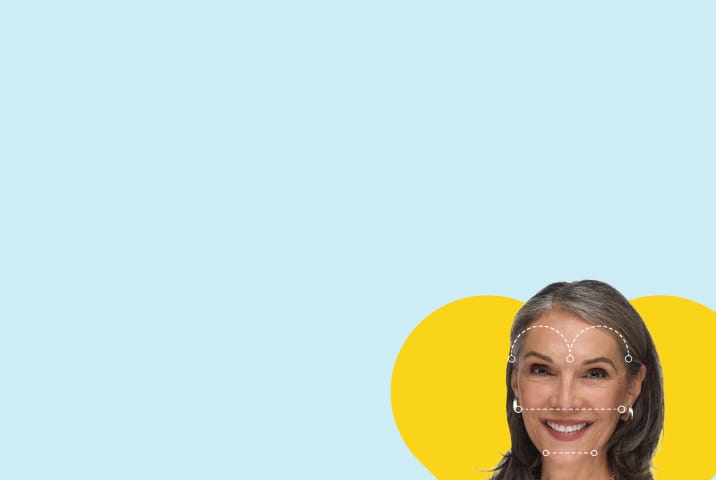 Smiling grey-haired woman with dashed lines tracing a heart face shape, set against a yellow heart background.