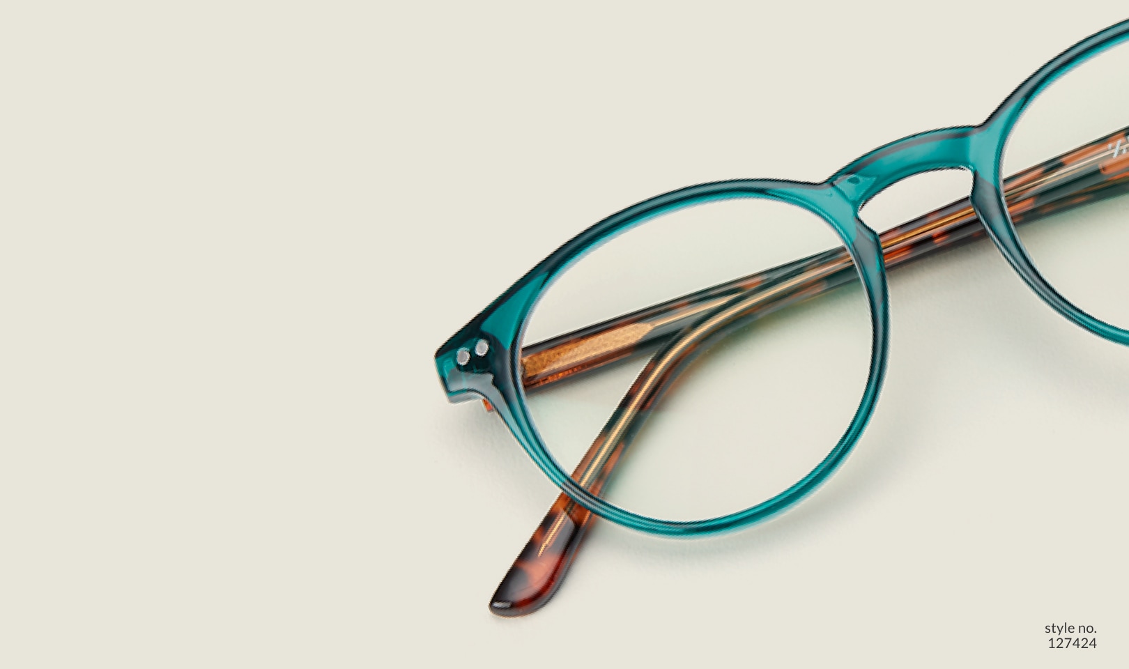 Image of Zenni green round glasses style #127424 shown with a light green background.